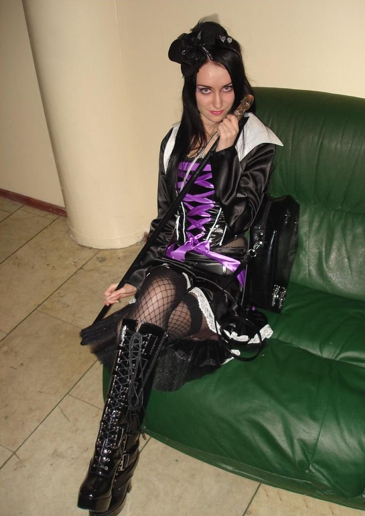 Brunette Gothic Girl wearing Black Fishnet Stockings and Black Short Dress